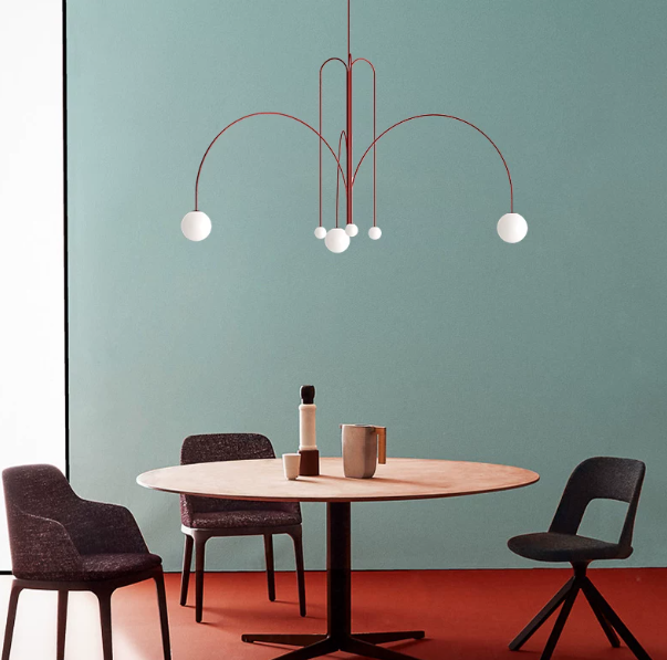 Glass branch chandelier above a modern dining table