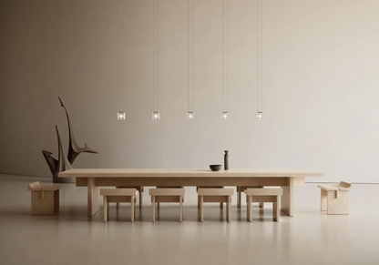 Minimal crystal glass cube pendant lights above a modern dining table