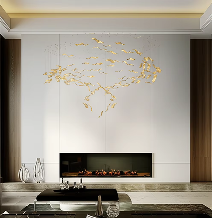 Gold leaf chandelier above modern fireplace in residential interior